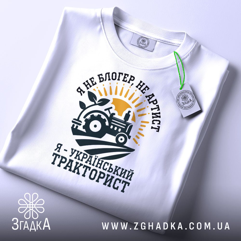 Складена біла футболка Український Тракторист з яскравим принтом та етикеткою згадка.