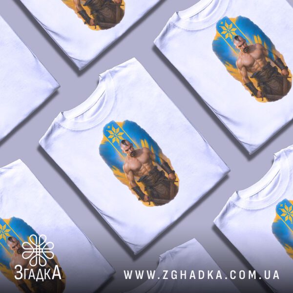 Кілька білих футболок з принтом "козацька сила Україна", складені стопкою або розкладені поруч на світлому фоні.