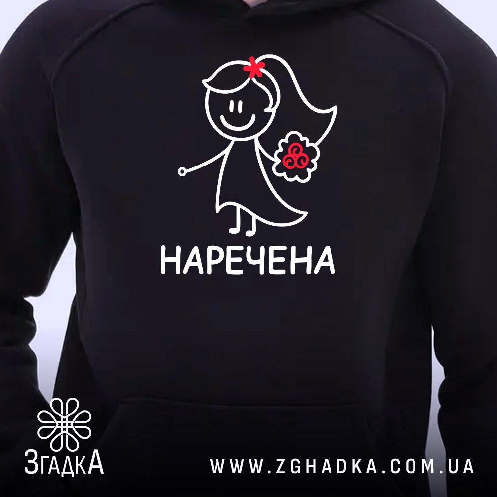 Чорне худі з принтом «Наречена», що висить на вішаку, демонструючи дизайн.
