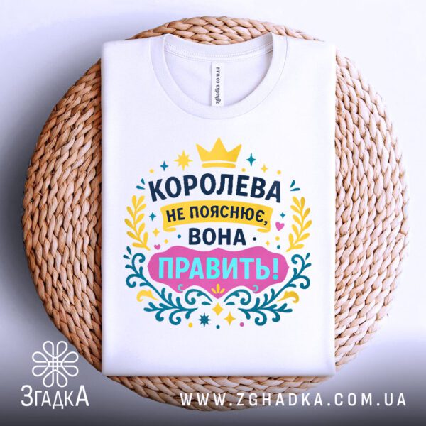 Футболка для справжньої королеви складена на декоративній поверхні, акцент на деталях принта.