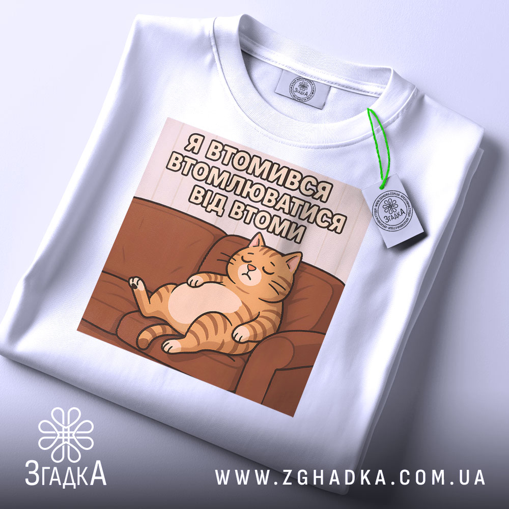 Футболка я втомився втомлюватися — чорна футболка, крупний план принта на нейтральному фоні.