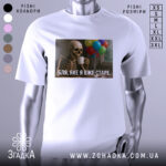 Футболка я вже старе. Біла футболка з принтом, на якому зображений скелет, що тримає чашку, на фоні кольорові повітряні кулі.