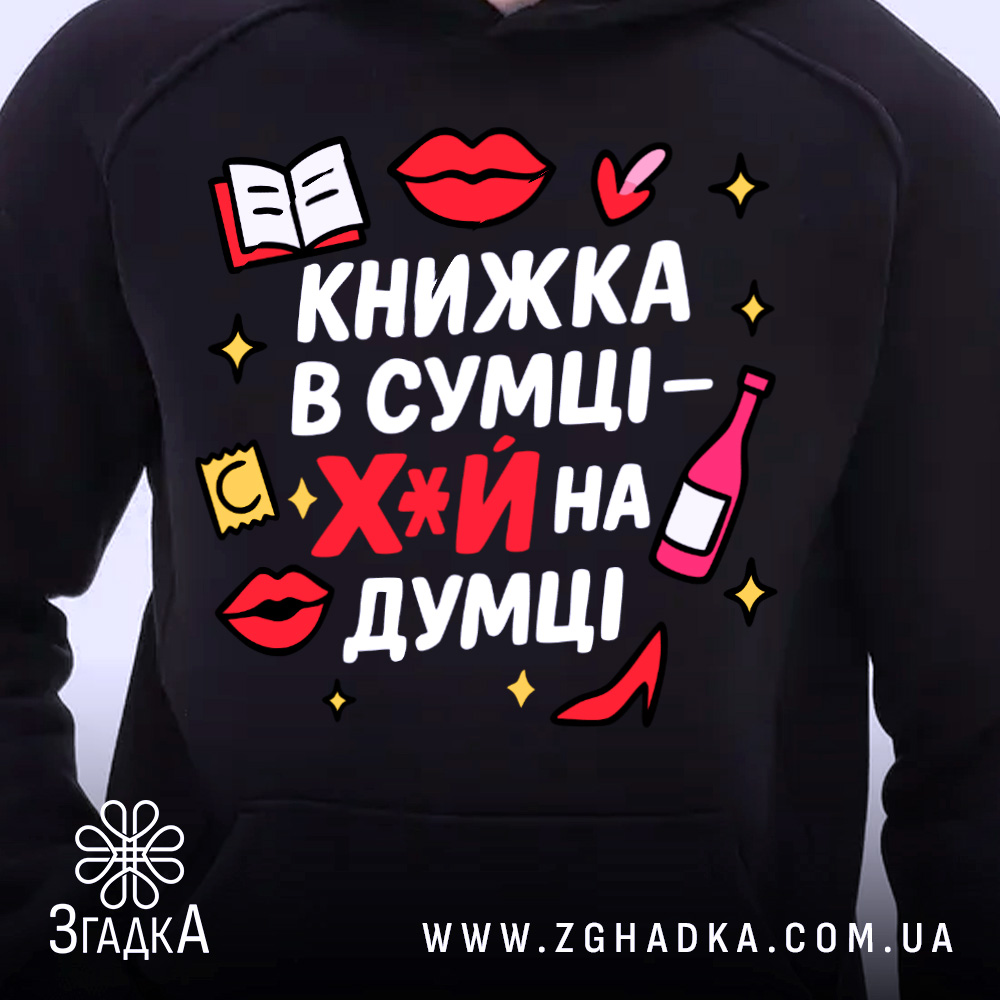 Худі книжка в сумці, темно-синього кольору, з капюшоном, з кишенею-«кенгуру», на фоні видно частину людини, яка його носить. Принт на грудях яскравий, з елементами червоного, жовтого та чорного кольорів, текст українською мовою.