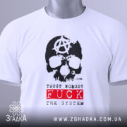 Футболка анархія проти системи, біла, зображена на столі, фон світлий, принт з черепом та анархічним символом, текст 'TRUST NOBODY FUCK THE SYSTEM' червоного кольору, на футболці є етикетка.