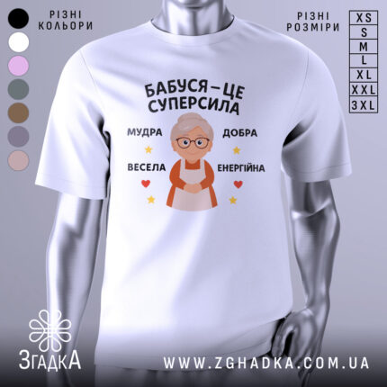 Футболка бабуся це суперсила, біла футболка з принтом, що зображує бабусю з окулярами, на фоні світло-сірого кольору, текст на футболці говорить 'Бабуся – це суперсила', оточений зірочками та сердечками.