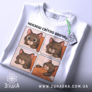 Футболка чекаєш світло, біла, зображена зверху, на фоні світло-сірого кольору, принт містить чотири квадрати з малюнками котів, які сплять, текст зверху: 'чекаєш світло ввечері', на комірці є етикетка з логотипом.