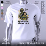 Футболка донька воїна ЗСУ, білого кольору, зображена на манекені, фон світло-сірий, принт з дівчиною, солдатом та голубом, яскраві жовті промені навколо.