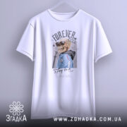 Футболка forever cool, білого кольору, підвішена на вішалці, фон світло-сірий, принт з черепом у сонцезахисних окулярах та синій куртці, текст 'Stay true' під малюнком.