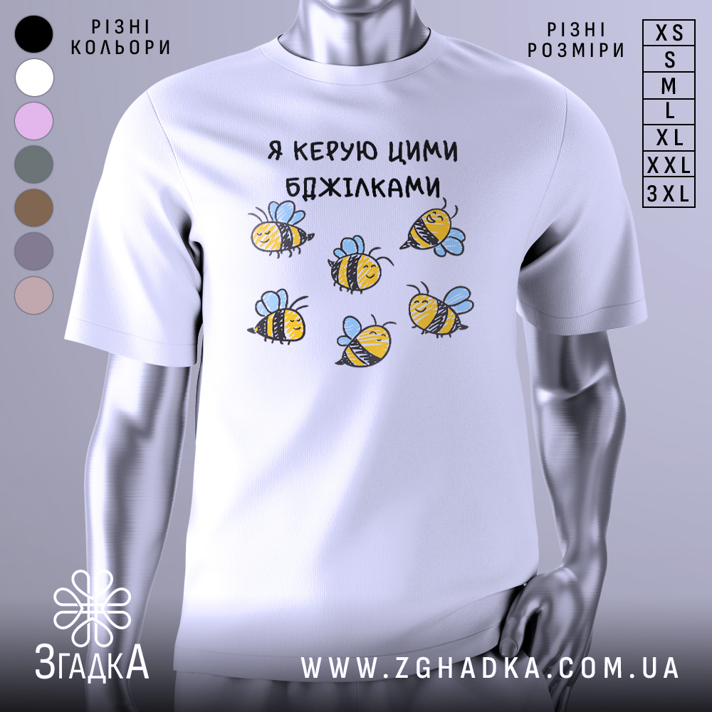 Футболка я керую бджілками, білого кольору, зображена з фронтального ракурсу на манекені, фон світло-сірий, принт з малюнками бджілок жовтого і чорного кольорів з блакитними крилами.