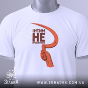 Футболка інтим не пропонувати, біла, зображена на столі, фон світло-сірий, принт з червоним серпом та текстом чорного кольору, на комірці є етикетка.