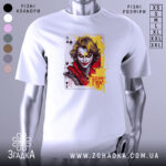 Футболка карта хаосу, біла, зображена на манекені, фон світло-сірий, принт з обличчям персонажа з картки, яскраві кольори жовтого та червоного, деталі обличчя виразні, текст "Доля Гра!".