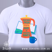 Футболка кава та книги, біла, зображена зверху, на фоні світло-сірого кольору, принт з кавоваркою, книгою та чашкою, яскраві кольори: оранжевий, жовтий, зелений, синій, текст українською мовою, з етикеткою на комірці.
