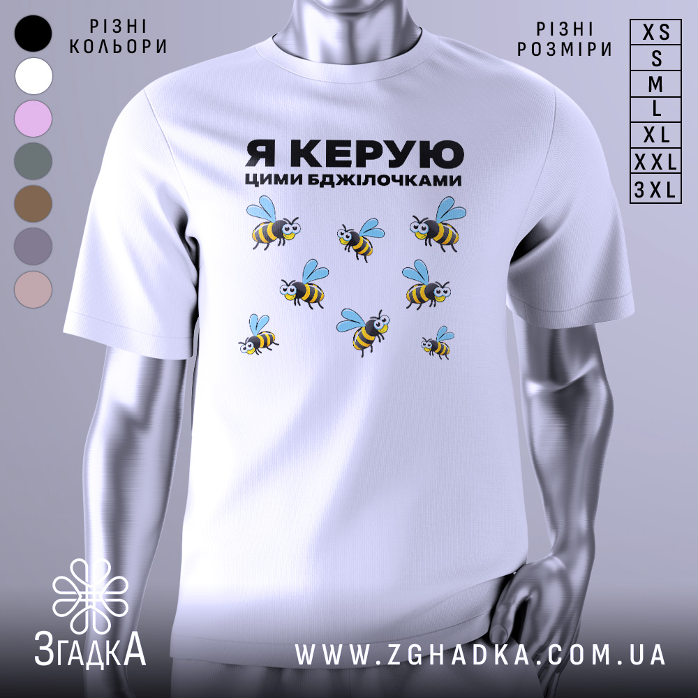 Футболка керую бджілочками, білого кольору, зображена на манекені з правого ракурсу, фон світло-сірий, принт з бджолами та написом "Я КЕРУЮ ЦИМИ БДЖІЛОЧКАМИ" в чорному кольорі.