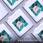 Футболка кіт незалежність, біла, зображена на манекені, фон світло-сірий, принт з котом та руками, що його обіймають, яскраві кольори принта.