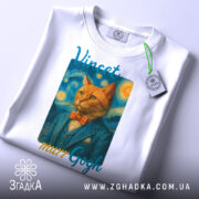 Футболка кіт Ван Гог білого кольору, складена на столі, фон світло-сірий, принт з котом у синьому костюмі та помаранчевому метелику, текст 'Vincent murrGogh' над принтом, на футболці підвісник з етикеткою.