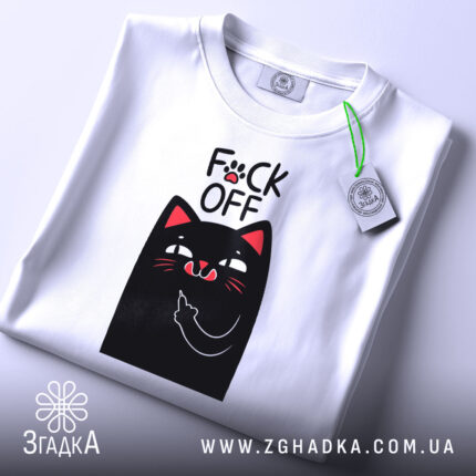Футболка котик фак офф, складена футболка білого кольору, з принтом чорного кота, який показує середній палець, фон світло-сірий, на комірці є етикетка.