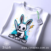 Футболка кролик з ножем, біла, зображена зверху, видно етикетку, фон світлий, принт з кроликом з ножем, яскраві кольорові сплески та напис 'FINE//NOT//FINE'.