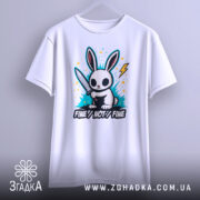 Футболка кролик з ножем, біла, підвішена на вішалці, фон світло-сірий, принт з кроликом, що тримає ніж, оточений кольоровими сплесками та написом 'FINE//NOT//FINE'.