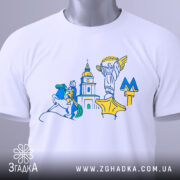 Футболка Київ білого кольору, складена на плоскій поверхні, фон світло-сірий, принт містить стилізовані зображення київських пам'яток, на футболці є етикетка з зеленим шнурком.