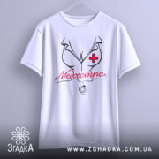 Футболка медсестра білого кольору, підвішена на вішалці, фон світло-сірий, принт з малюнком медсестри та написом 'Медсестра' червоного кольору.