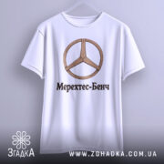 Футболка Мерехтес-Бенч стиль, біла, підвішена на вішалці, фон світло-сірий, принт з дерев'яним логотипом і написом 'Мерехтес-Бенч' чорного кольору.