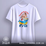 Футболка найкращий кум, біла, підвішена на вішалці, фон світло-сірий, принт з персонажем, який тримає їжу, текст "НАЙКРАЩИЙ КУМ" червоним шрифтом, видно округлі краї рукавів.