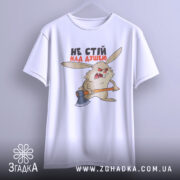 Футболка не стій над душею, біла, підвішена на вішалці, фон світло-сірий, принт з агресивним кроликом з сокирою, текст чорного та червоного кольору.