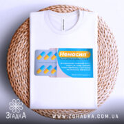 Футболка немасил терпіти, біла, складена на плетеній кошику, фон натуральний, принт з упаковкою капсул, жовті та блакитні кольори, текст на принті українською мовою.