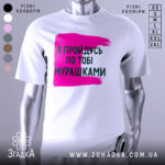 Футболка пройдусь мурашками, біла, зображена на манекені, фон нейтральний, принт у вигляді рожевої смуги з текстом чорного кольору.