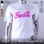 Футболка стиль барбі, біла, зображена на манекені, фон нейтральний, принт з написом 'Barbie' яскравого рожевого кольору з квіткою.