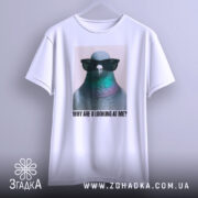 Футболка стильний голуб, біла, зображена з фронтального ракурсу, фон світло-сірий, принт з птахом у сонцезахисних окулярах, текст під ним: 'WHY ARE U LOOKING AT ME?', футболка підвішена на вішалці.