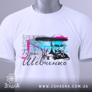 Футболка Тарас Григорович Шевченко, біла, складена на поверхні, фон світло-сірий, принт з портретом Шевченка, кольорові акценти в блакитному та рожевому, на комірці є етикетка.
