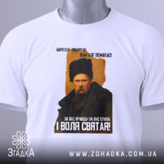 Футболка Тарас Шевченко борітеся, біла футболка, зображення Тараса Шевченка з принтом, футболка складена, фон білий, текст на футболці чорний і жовтий, етикетка зеленого кольору.