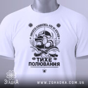 Футболка тихе полювання, білого кольору, складена на поверхні, фон світло-сірий, принт чорного кольору з елементами грибів та ножів, на футболці є зелена етикетка.