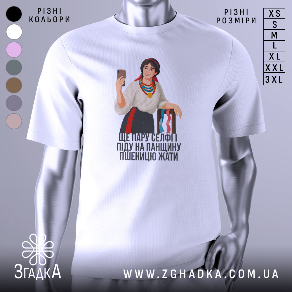 Futbolka Ukrainska Selfi Krasunia Khit Sezonu 1 Футболка українська селфі красуня, біла, зображена з фронтального ракурсу, на фоні світло-сірого кольору, принт з дівчиною в національному вбранні, яка тримає телефон і посміхається, текст під малюнком: 'ЩЕ ПАРУ СЕЛФІ ПІДУ НА ПАНЦІЮ ПШЕНИЦЮ ЖАТИ'.