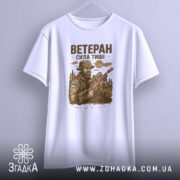 Футболка ветеран білого кольору, зображена на манекені, ракурс спереду, фон градієнтний сірий, принт з військовим, що тримає гвинтівку, з елементами природи та українським прапором на формі.