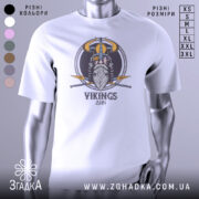 Футболка вікінги одін, біла, зображена з фронтального ракурсу на манекені, фон світло-сірий, принт з зображенням вікінга з рогатим шоломом та мечами, текст 'VIKINGS' під малюнком.