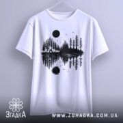 Футболка з природою, біла, підвішена на вішалці, фон світло-сірий, принт з чорними деревами, озером і сонцем, деталі принта включають відображення в воді.