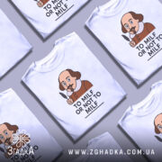 Футболка з шекспіром, білого кольору, зображена з близького ракурсу на манекені, фон нейтральний, принт з карикатурним зображенням Шекспіра з пером в руці та написом 'TO MILF OR NOT TO MILF'.