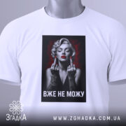 Футболка жінка тату білого кольору, зображена в горизонтальному ракурсі, фон світлий, принт з чорно-білою жінкою з червоними губами та татуюваннями, текст "ВЖЕ НЕ МОЖУ" під зображенням, на футболці є етикетка з зеленим шнурком.