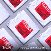 Футболка Житомир, біла, зображена на манекені, фон світло-сірий, принт червоний з малюнком підвісного мосту та написом 'Житомир'.