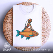 Футболка дівчина на рибі, біла, з верхнього ракурсу, складена на плетеній кошику, принт з дівчиною в аквалангу на рибі.