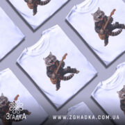 Футболка котик рокер гітарист, біла, зображена на манекені, фон світло-сірий, принт з котом у рокерському вбранні, який грає на гітарі, з виразом енергії та емоцій.