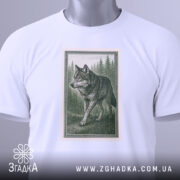 Футболка лісовий вовк, біла, складена на столі, фон світло-сірий, принт з лісовим вовком у зелених тонах, прикріплена етикетка з логотипом.