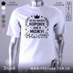 Футболка не всі носять корону. Біла футболка на манекені, з принтом чорного кольору, на якому написано 'НЕ ВСІ НОСЯТЬ КОРОНУ, АЛЕ Я МОЖУ!'. Фон світло-сірий, з легким градієнтом.