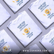 Футболка нехай буде світло. Біла футболка з принтом, зображення на грудях, ракурс спереду, фон світлий, принт з жовтою лампочкою та текстом у синьому кольорі.