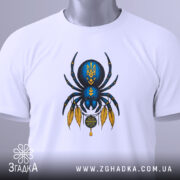 Футболка павук з тризубом, біла, зображена зверху, фон світло-сірий, принт з павуком синього кольору з жовтими деталями, на футболці є етикетка з логотипом.