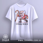 Футболка Принц Пенсії білого кольору, підвішена на вішалці, фон світло-сірий, принт з дідусем у червоній сорочці, який тримає палицю, з виразом обличчя, що показує емоції.