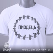 Футболка пиздець, біла, складена на поверхні, фон світло-сірий, принт з мишами, що тримаються за руки, текст "ПИЗДЕЦЬ" великими літерами, з етикеткою зеленого кольору.
