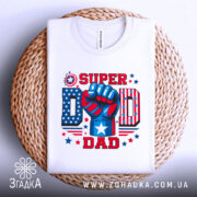 Футболка супер тато, біла, складена на плетеній основі, фон світлий, принт яскравий з червоним, синім та білим кольорами, кулак з написом 'SUPER DAD' та зірками.